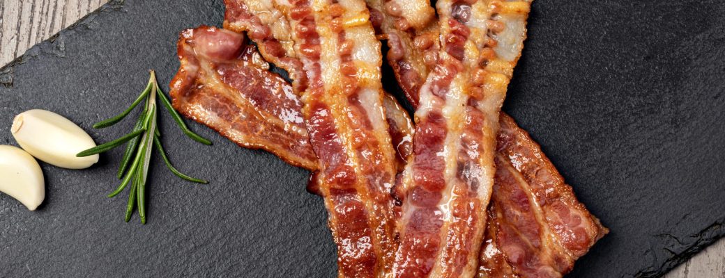 Closeup Of Slices Of Crispy Hot Fried Bacon