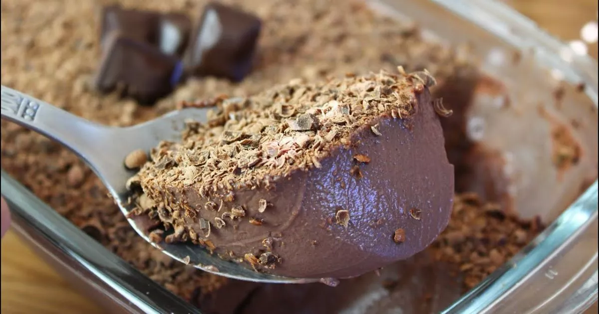 Mousse de Nescau cremosa em uma tigela decorada com raspas de chocolate.